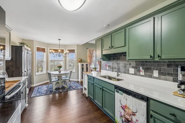 a kitchen with stainless steel appliances granite countertop a sink a counter space and cabinets