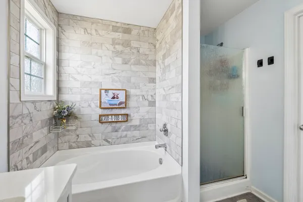 a bathroom with a bathtub and shower