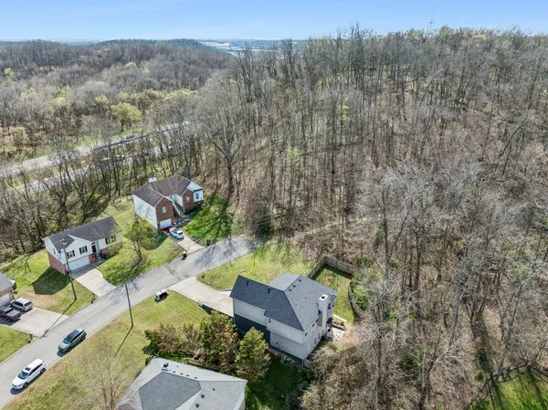an aerial view of a house with a yard