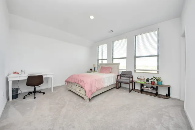 a spacious bathroom with a toilet sink and mirror