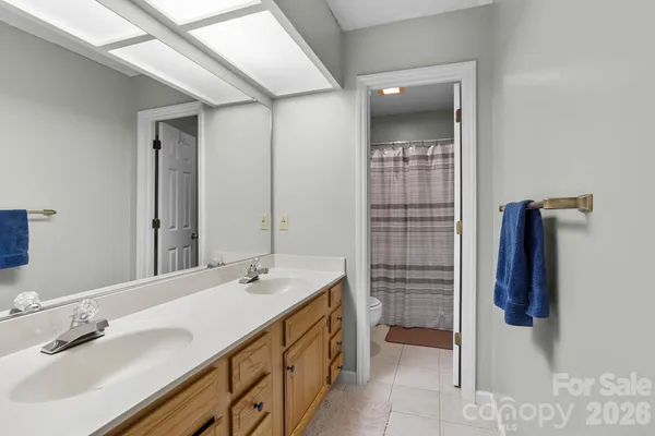 a bathroom with a double vanity sink and a mirror