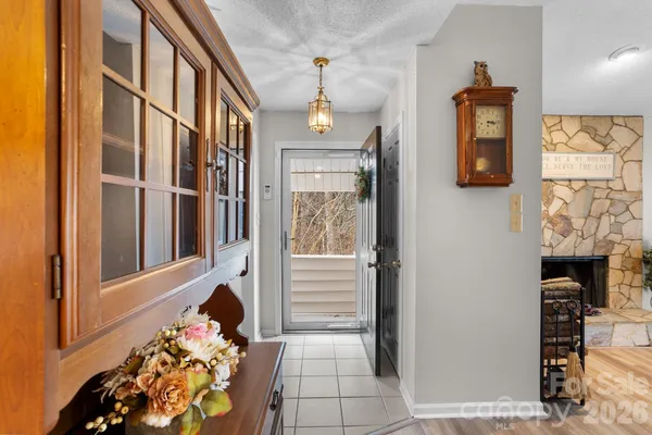 a hallway with fireplace and wooden floor