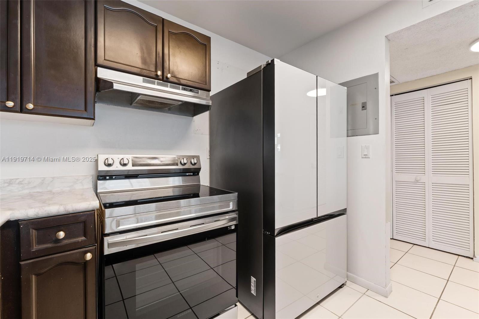2301 Collins Avenue, Unit 802 Miami Beach, FL 33139 - Photo 11 of 26 a view of kitchen with refrigerator and cabinets