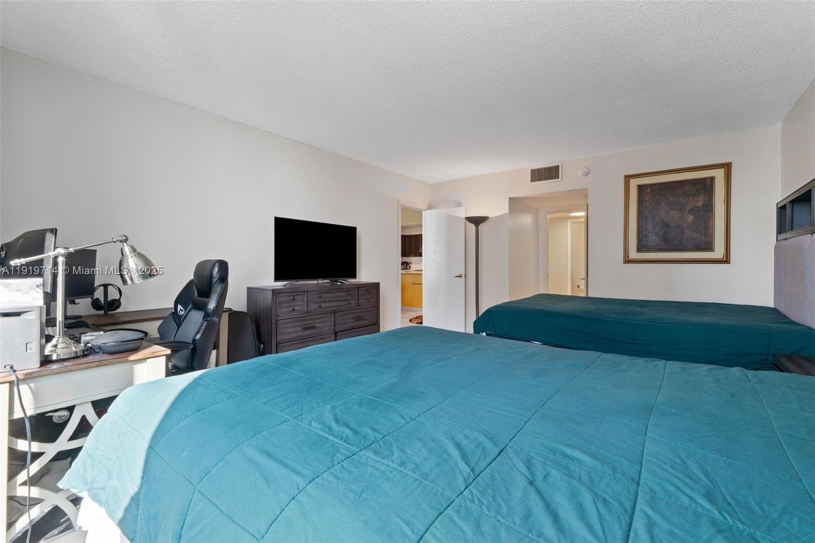 2301 Collins Avenue, Unit 802 Miami Beach, FL 33139 - Photo 22 of 26 a bedroom with a bed and a flat screen tv