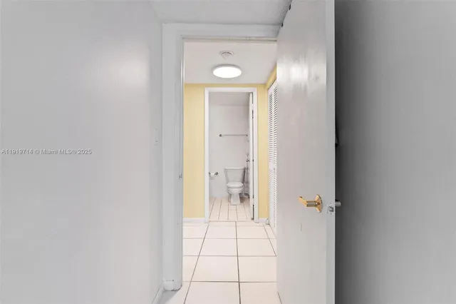 a bathroom with a granite countertop sink a toilet and a mirror