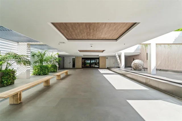 a living room with furniture and potted plant