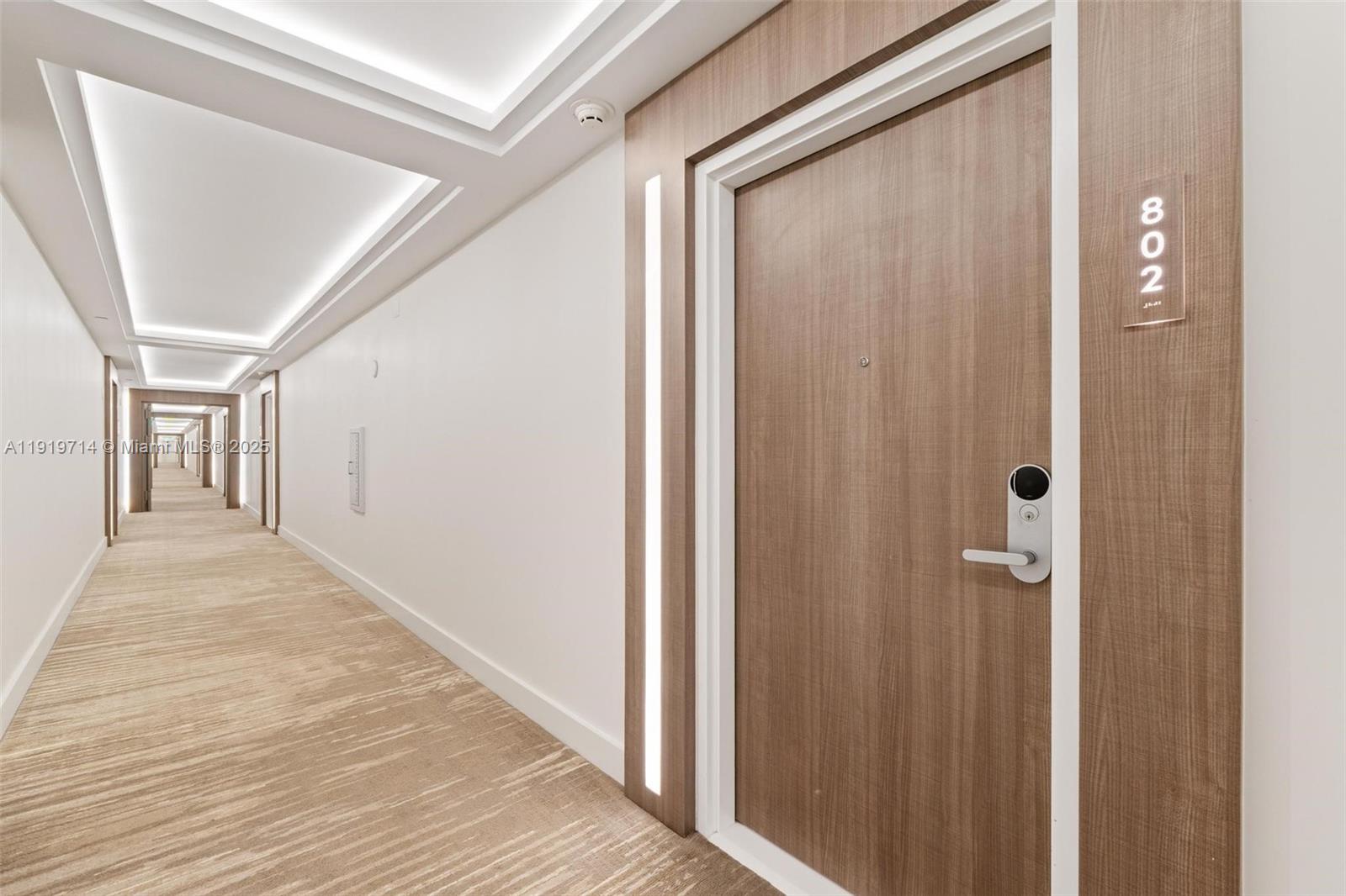 2301 Collins Avenue, Unit 802 Miami Beach, FL 33139 - Photo 5 of 26 a view of a hallway with wooden floor and staircase