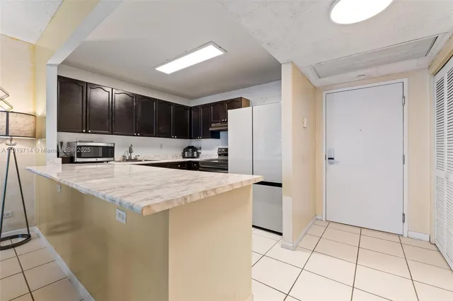 a kitchen with a sink a stove and cabinets