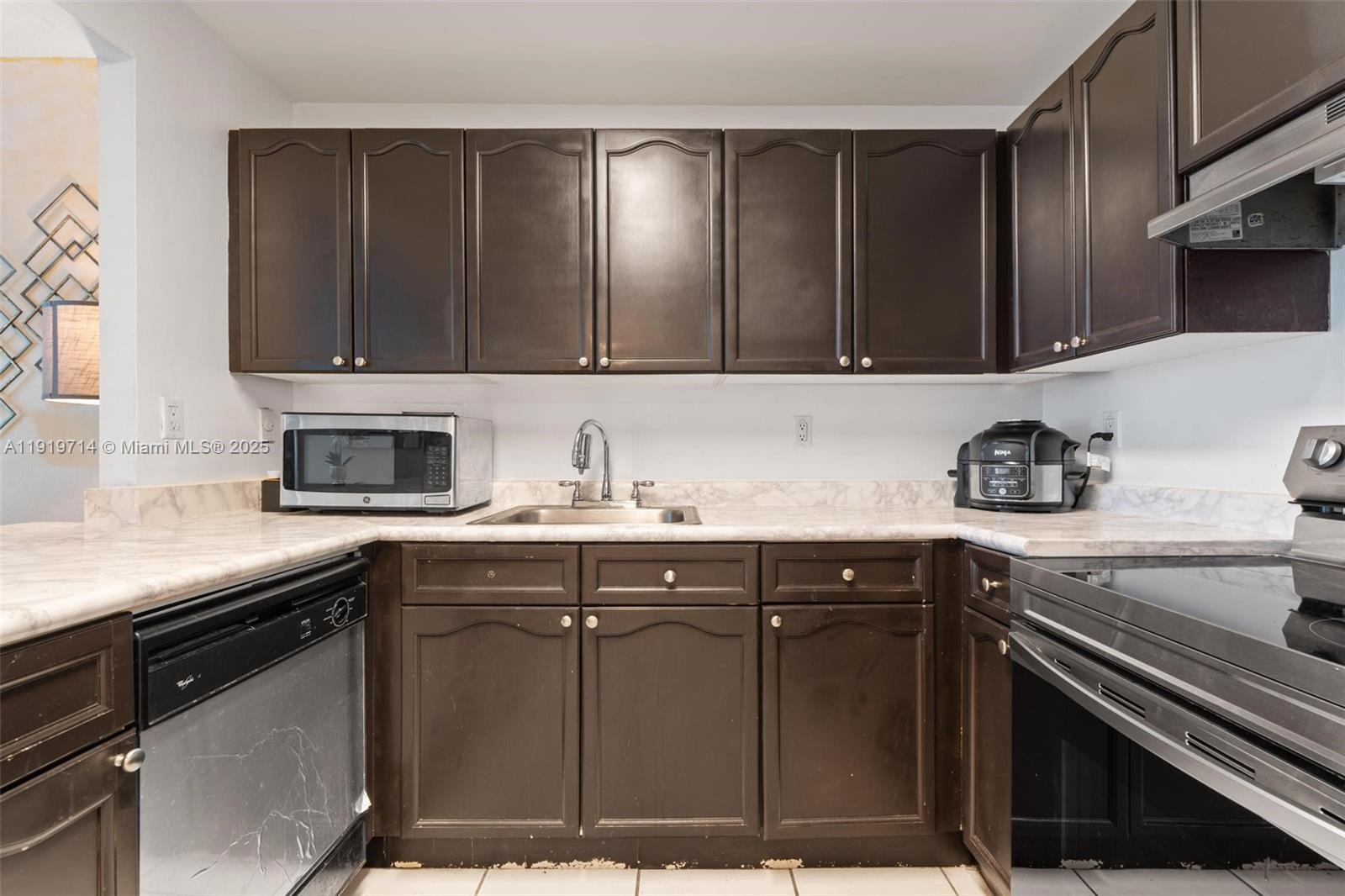 2301 Collins Avenue, Unit 802 Miami Beach, FL 33139 - Photo 10 of 26 a kitchen with a sink and cabinets