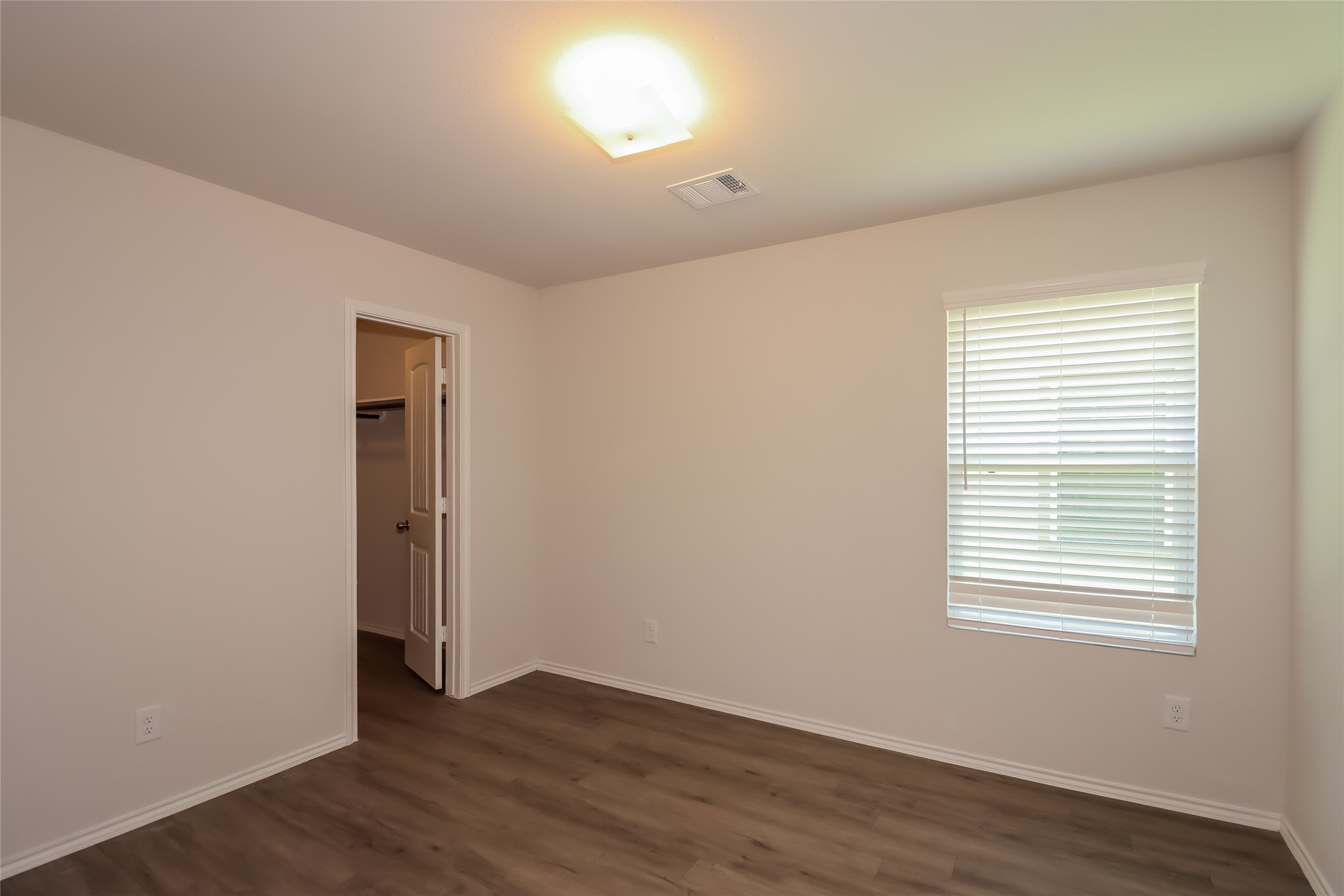 3708 Alexus Drive Conroe, TX 77301 - Photo 14 of 20 an empty room with wooden floor and windows