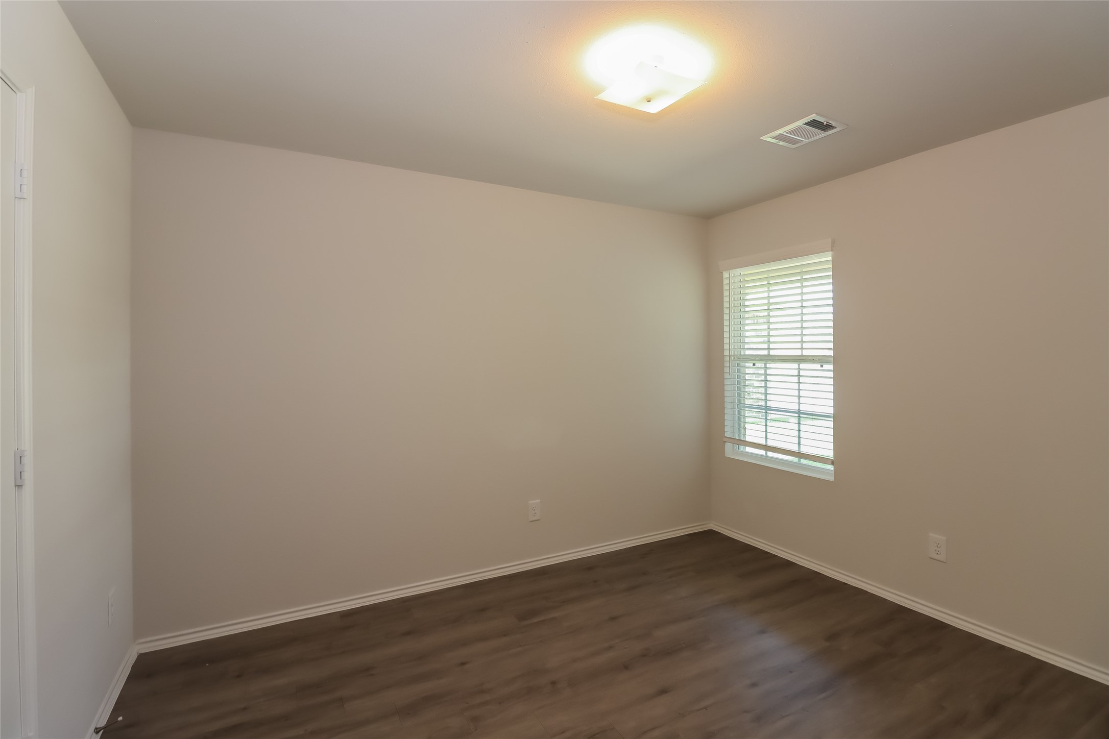 3708 Alexus Drive Conroe, TX 77301 - Photo 15 of 20 an empty room with wooden floor and windows