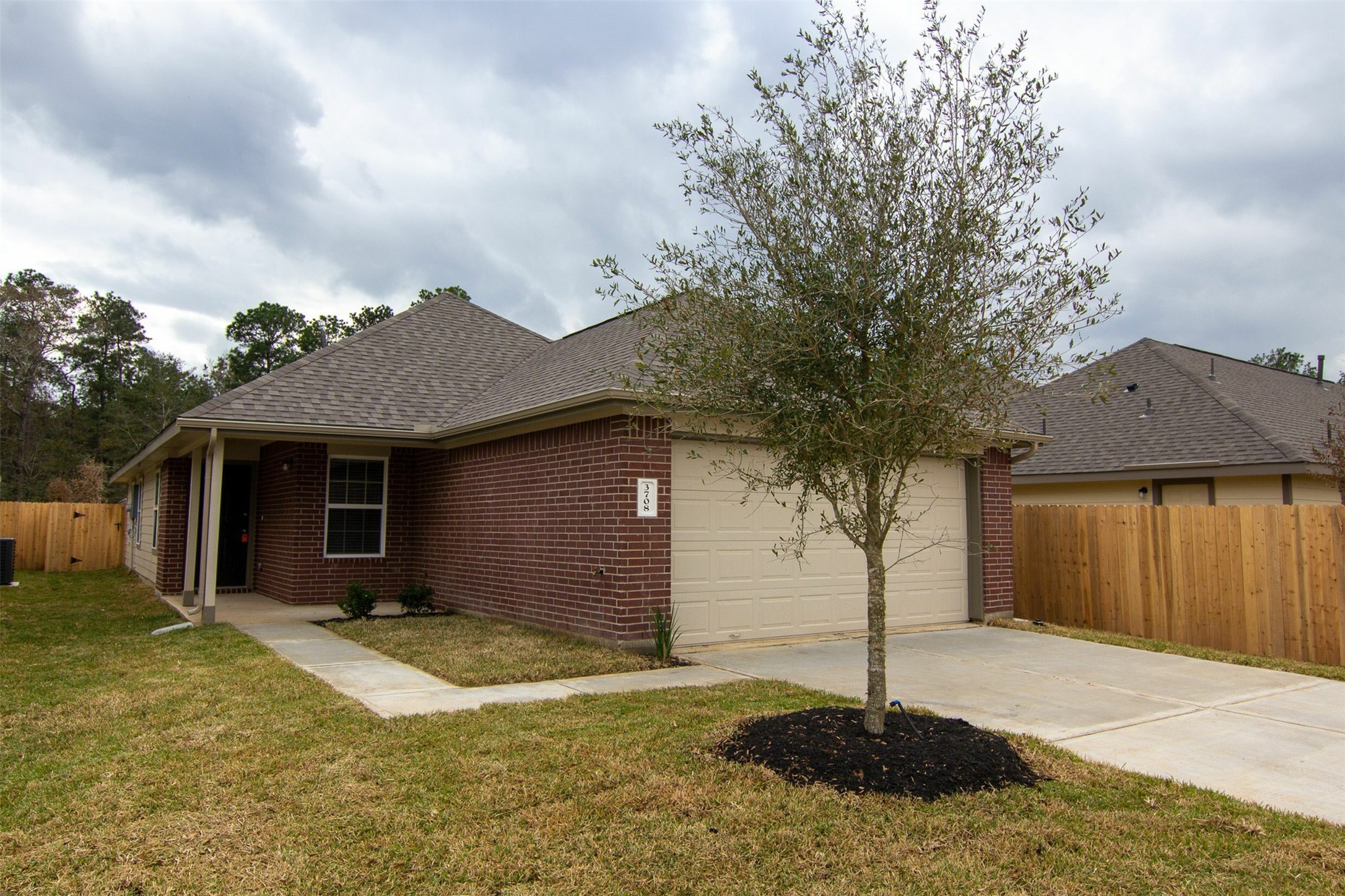 3708 Alexus Drive Conroe, TX 77301 - Photo 2 of 20 a front view of a house with a yard and garage