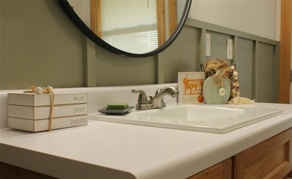 765 Addison Road Buchanan, GA 30113 - Photo 23 of 34 a bathroom with a sink and a mirror