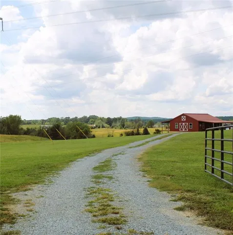 a living room with furniture wooden floor and a large window