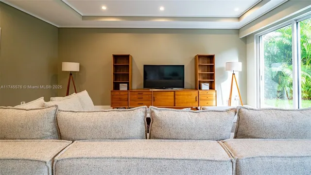 a living room with furniture and a flat screen tv