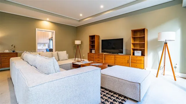 a dining room with furniture and a floor to ceiling window