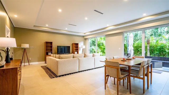 a view of a room with a mirror and a hardwood