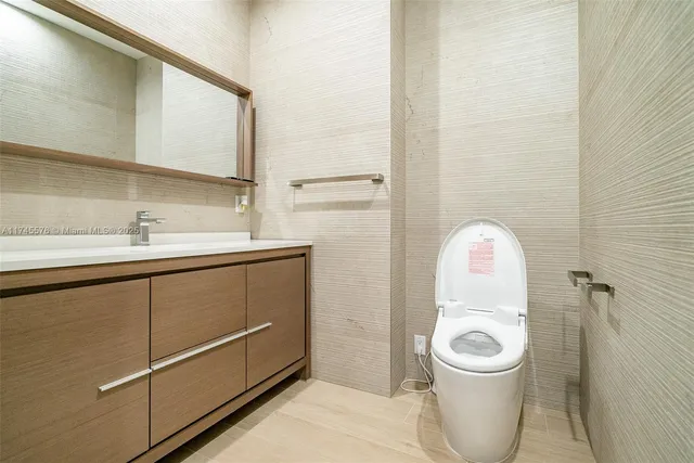 a large bed sitting in a bedroom next to a window