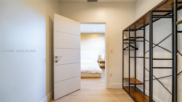 a bedroom with a bed and wooden floor