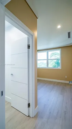a dining room with furniture and a floor to ceiling window