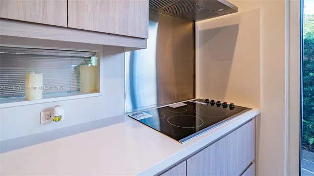 a kitchen with stainless steel appliances a refrigerator a stove a sink and a microwave