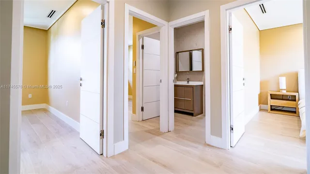 a view of a patio with couches table and chairs under an umbrella