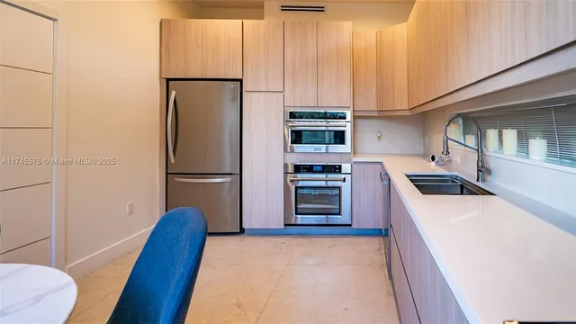 a kitchen with stainless steel appliances a refrigerator and a stove top oven
