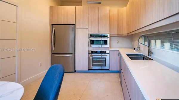 a kitchen with stainless steel appliances a refrigerator and a stove