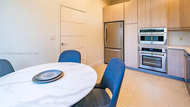 a living room with furniture kitchen view and large windows