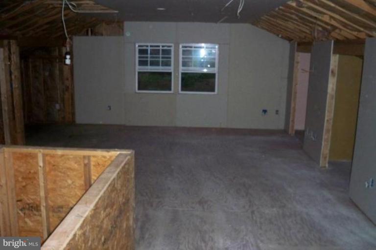 1846 Tank Road Finksburg, MD 21048 - Photo 6 of 6 a view of an empty room with wooden floor and a window