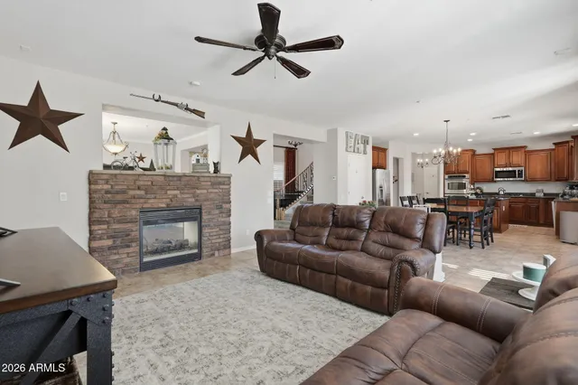 a spacious bedroom with a bed and a ceiling fan