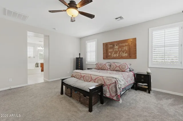 a spacious bathroom with a double vanity sink a mirror and shower