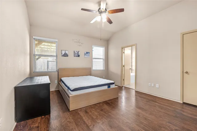 a view of a house with a yard and a large tree