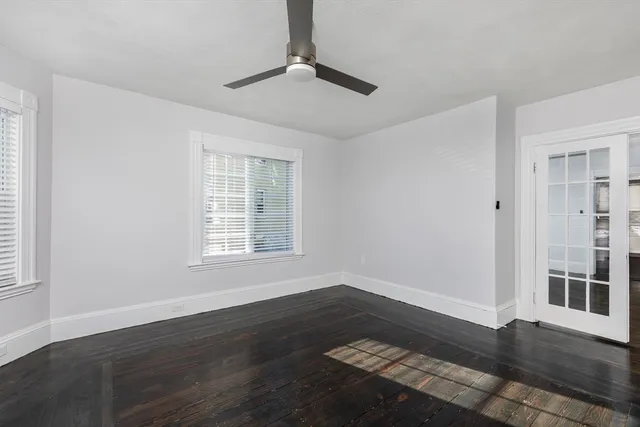 a view of wooden floor in an empty room with a window