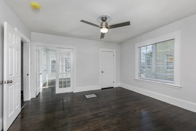 wooden floor in an empty room with a window