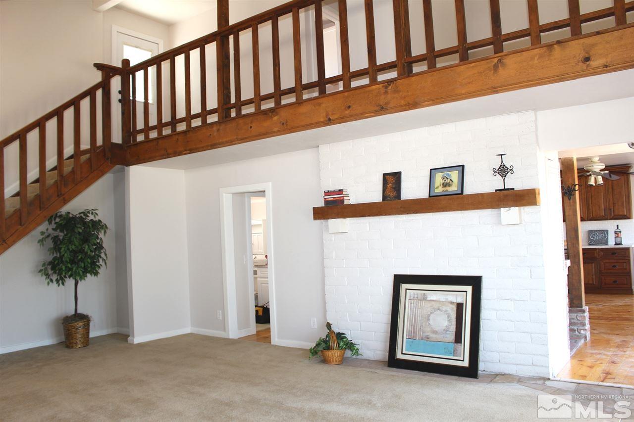 15380 Yankee Blade Road Reno, NV 89521 - Photo 2 of 40 a view of staircase with lots of frames and flower