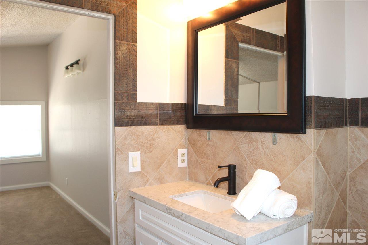 15380 Yankee Blade Road Reno, NV 89521 - Photo 23 of 40 a bathroom with a sink and a mirror