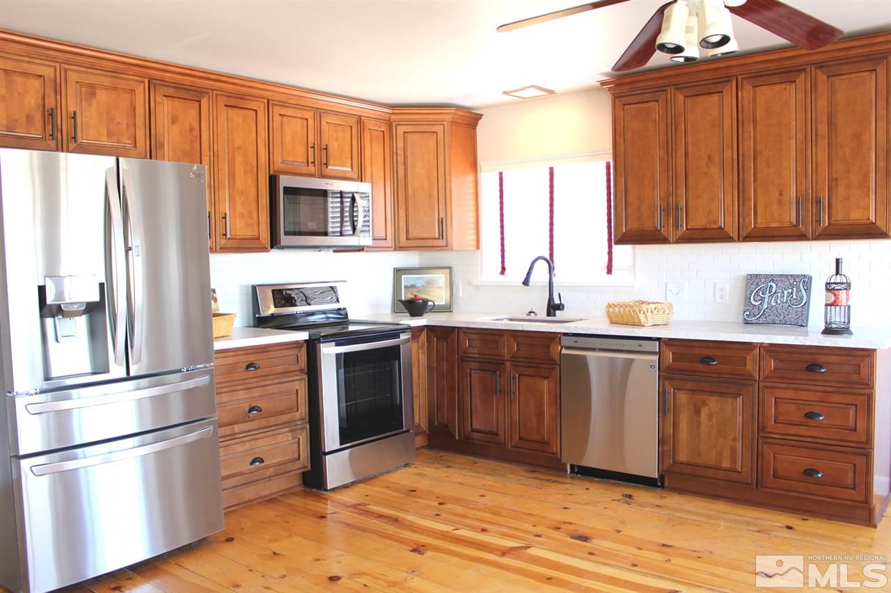 15380 Yankee Blade Road Reno, NV 89521 - Photo 9 of 40 a kitchen with stainless steel appliances granite countertop a refrigerator stove and sink