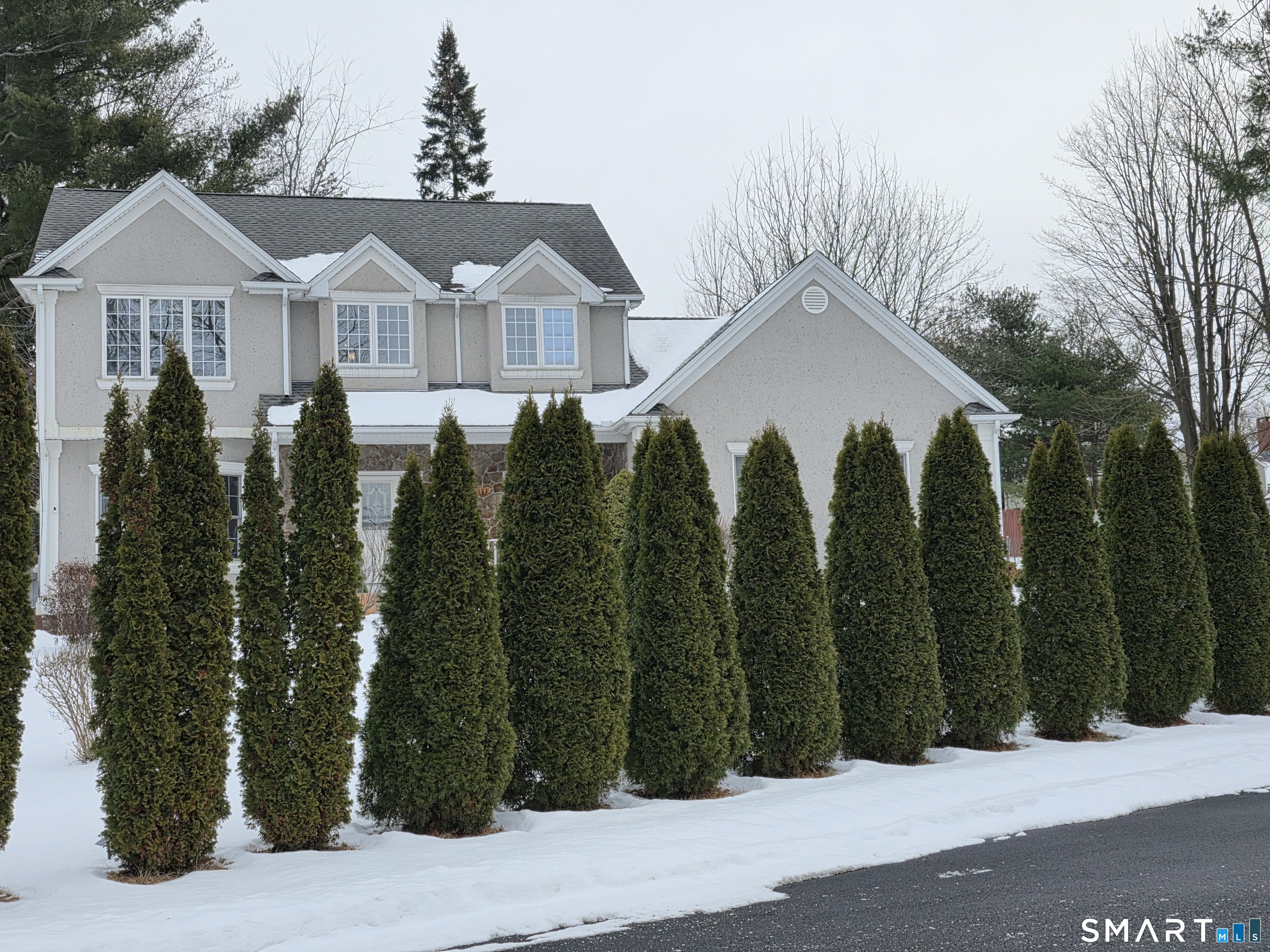 83 Robin Street Bristol, CT 06010 - Photo 3 of 9 a view of a white house with a small yard and plants