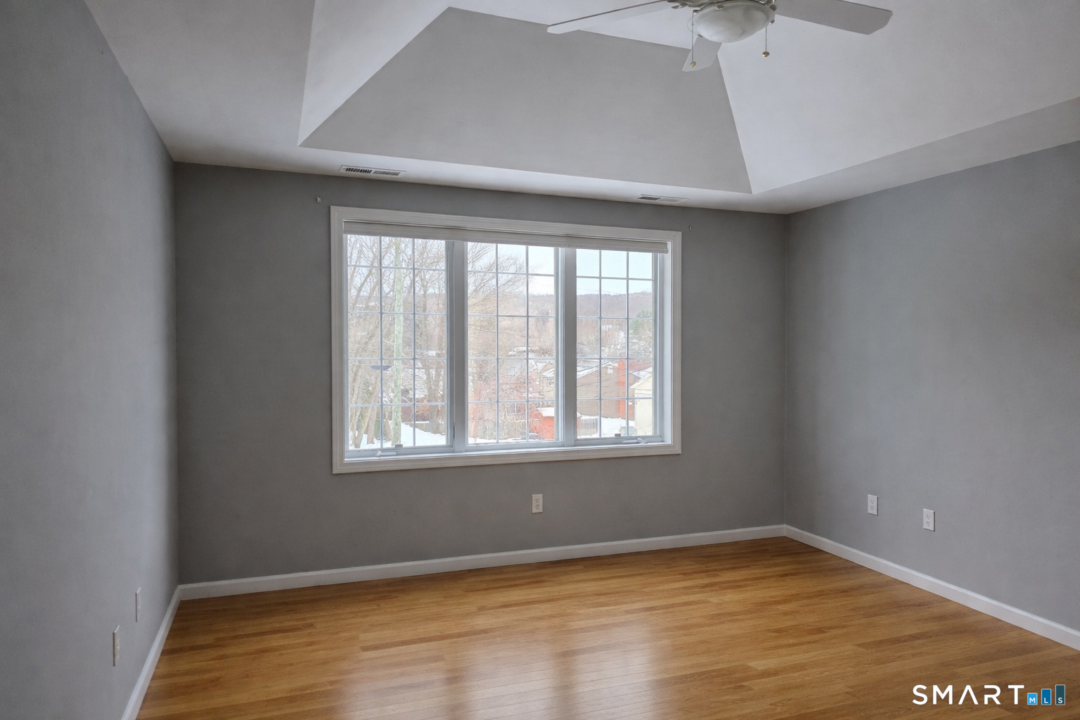 83 Robin Street Bristol, CT 06010 - Photo 7 of 9 an empty room with wooden floor and windows