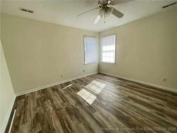 a view of room with window and ceiling fan