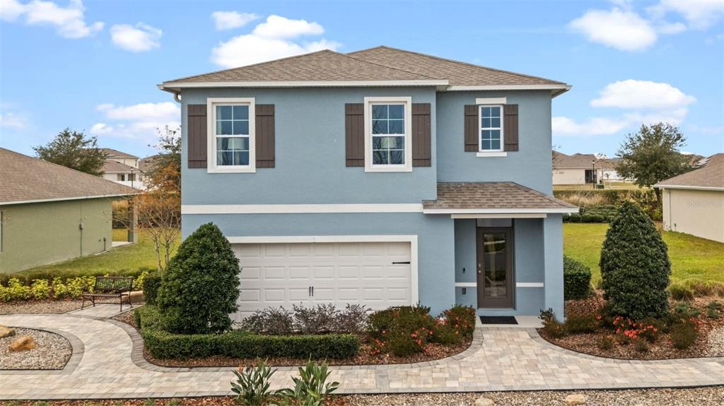 a front view of a house with garden