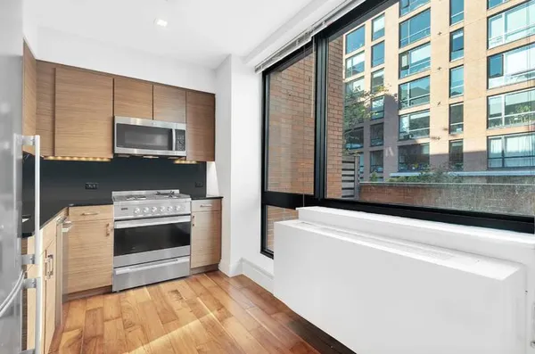 a kitchen with granite countertop a sink and a stove top oven