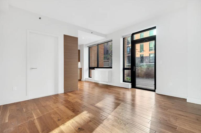 537 West 27th Street, Unit 2D Manhattan, NY 10001 - Photo 4 of 14 a view of an empty room with glass door