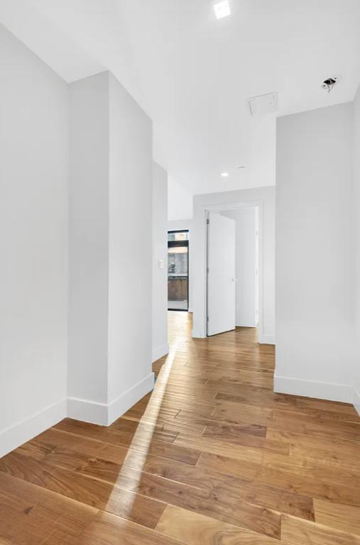 537 West 27th Street, Unit 2D Manhattan, NY 10001 - Photo 6 of 14 a view of an empty room with wooden floor