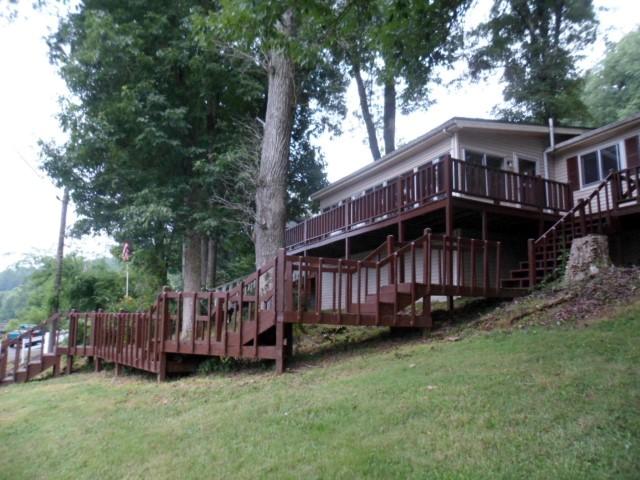 796 Lake Logan Road Ardmore, TN 38449 - Photo 12 of 14 a view of a house with a yard and deck wooden fence