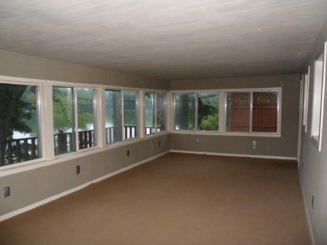 796 Lake Logan Road Ardmore, TN 38449 - Photo 4 of 14 wooden floor in an empty room with a window
