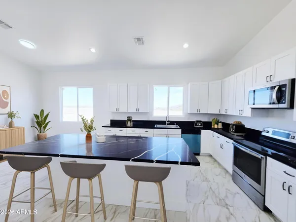 a bathroom with a double vanity sink mirror and shower