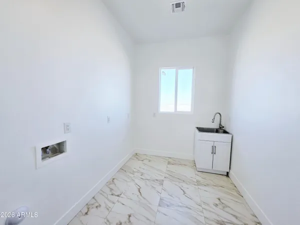 a view of a livingroom with a ceiling fan and window