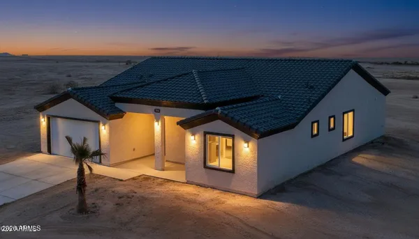 a kitchen with stainless steel appliances granite countertop a stove top oven a sink a refrigerator and white cabinets